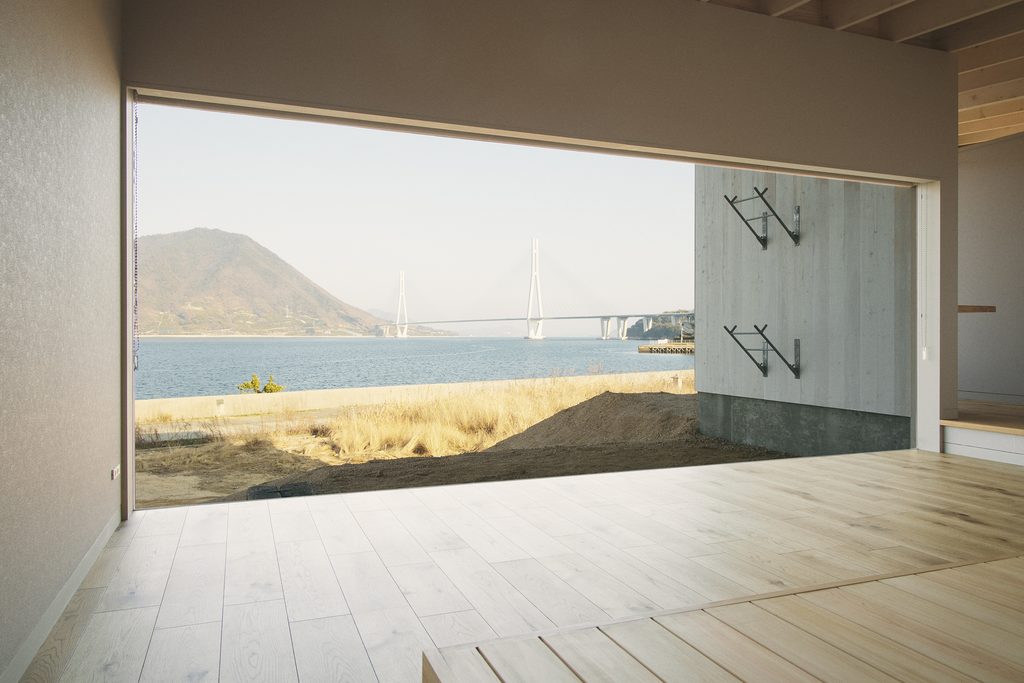 Interior of a WAKKA residence with a large opening overlooking the Seto Inland Sea and Tatara Bridge.